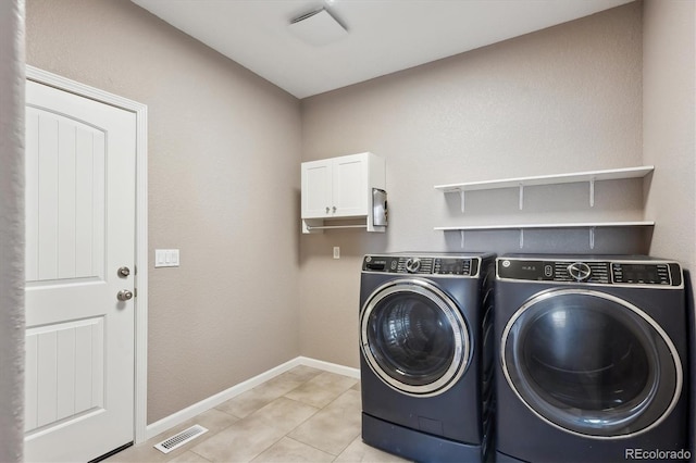 laundry room featuring light tile patterned floors, cabinet space, baseboards, visible vents, and independent washer and dryer