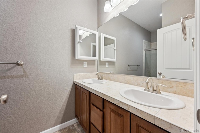 full bath with double vanity, a stall shower, a sink, and decorative backsplash