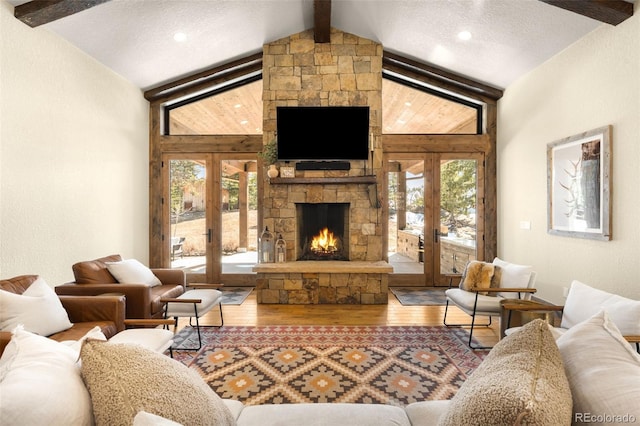 living room featuring wood finished floors, vaulted ceiling with beams, french doors, and a textured ceiling