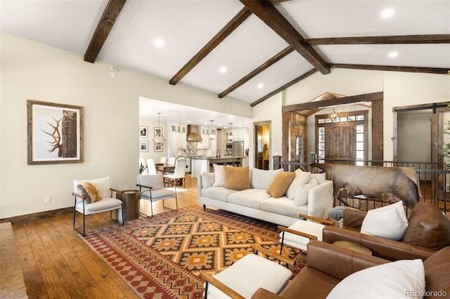 living area with baseboards, hardwood / wood-style floors, beam ceiling, recessed lighting, and high vaulted ceiling