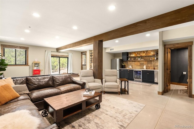 living area featuring beamed ceiling, visible vents, recessed lighting, wine cooler, and bar area