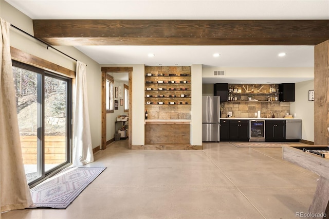 bar featuring visible vents, concrete floors, wet bar, wine cooler, and appliances with stainless steel finishes