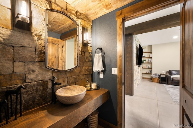 bathroom featuring tile patterned flooring and a sink