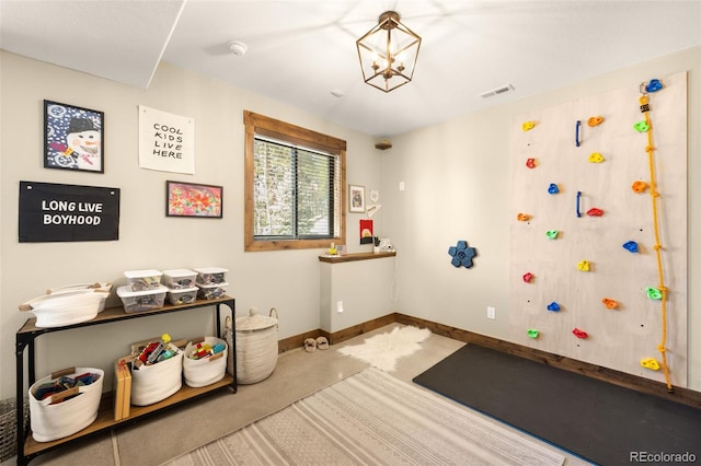 rec room featuring carpet, an inviting chandelier, baseboards, and visible vents