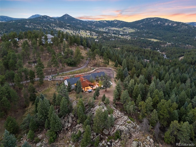 aerial view at dusk with a forest view and a mountain view