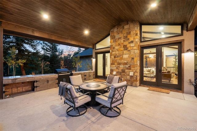 view of patio / terrace with french doors, a fire pit, and area for grilling