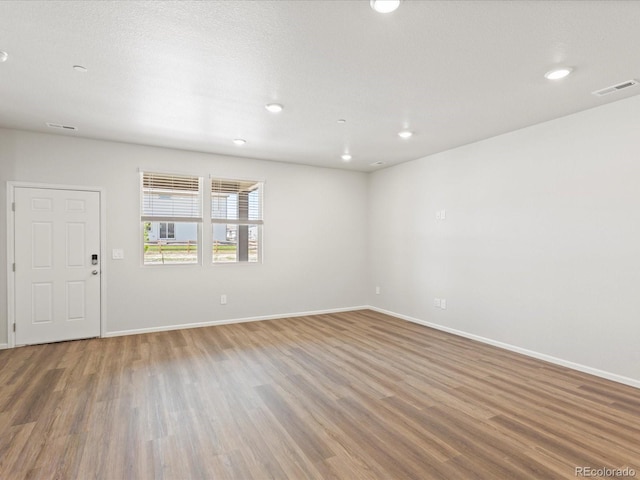 1618 Riverplace Dr Unit 2, Windsor, CO 80550 - unfurnished room featuring wood finished floors, baseboards, and recessed lighting