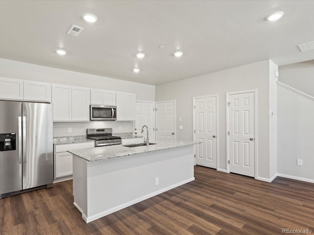 1618 Riverplace Dr Unit 2, Windsor, CO 80550 - kitchen featuring stainless steel appliances, a sink, dark wood-type flooring, white cabinetry, and recessed lighting