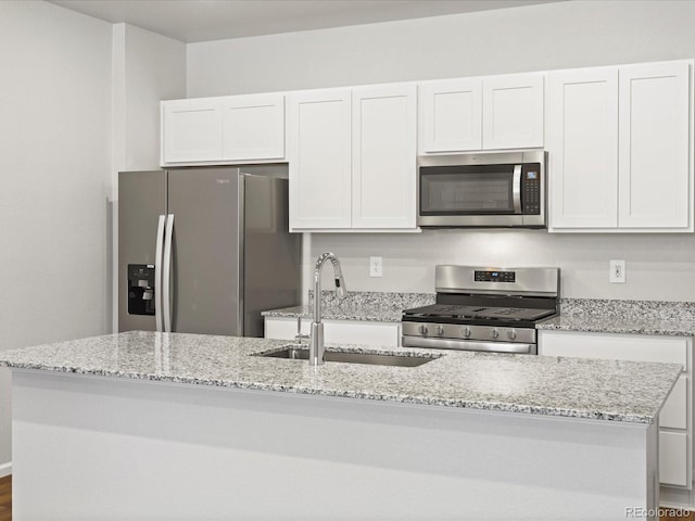 1618 Riverplace Dr Unit 2, Windsor, CO 80550 - kitchen with stainless steel appliances, a sink, white cabinetry, and light stone counters