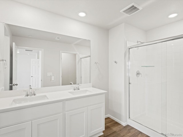 1618 Riverplace Dr Unit 2, Windsor, CO 80550 - full bath featuring a stall shower, double vanity, wood finished floors, recessed lighting, and baseboards