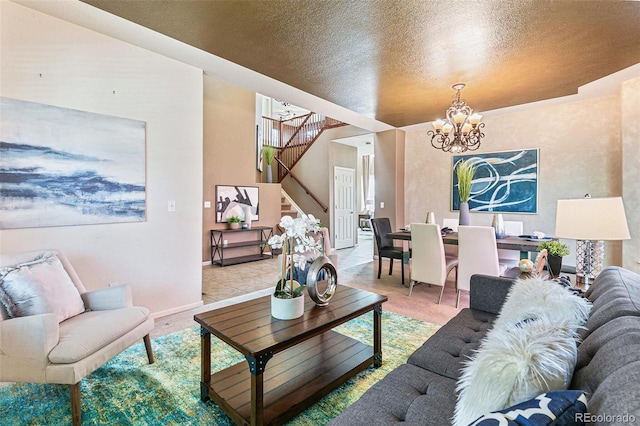 living room with light tile patterned flooring, a notable chandelier, and a textured ceiling