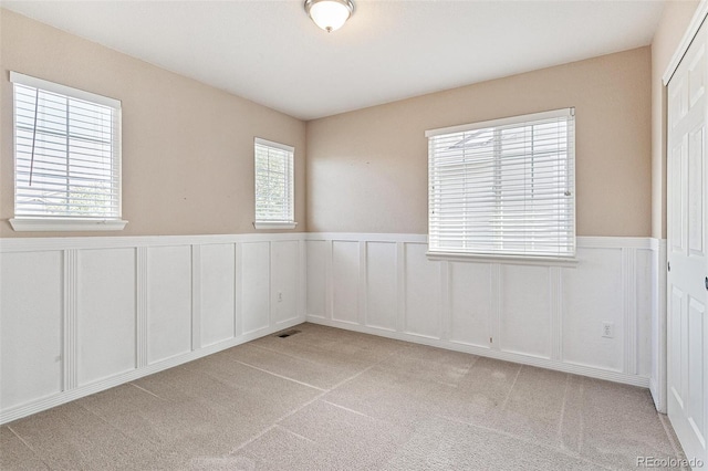 unfurnished room with light colored carpet