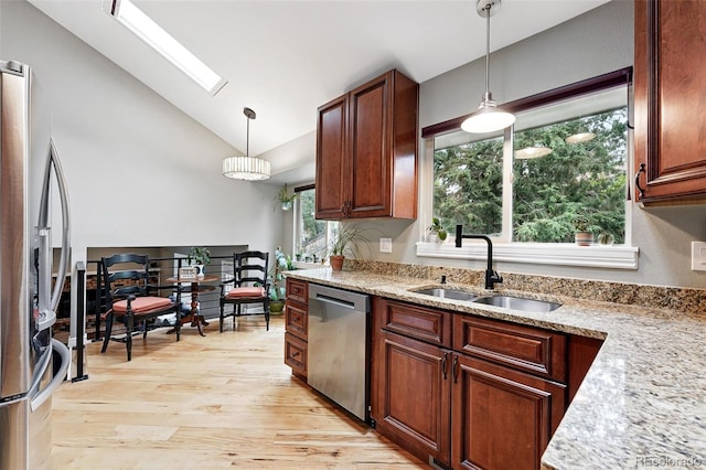 6248 E Mineral Pl, Centennial, CO 80112 - kitchen featuring stainless steel appliances, a sink, light wood-style floors, a skylight, and hanging light fixtures