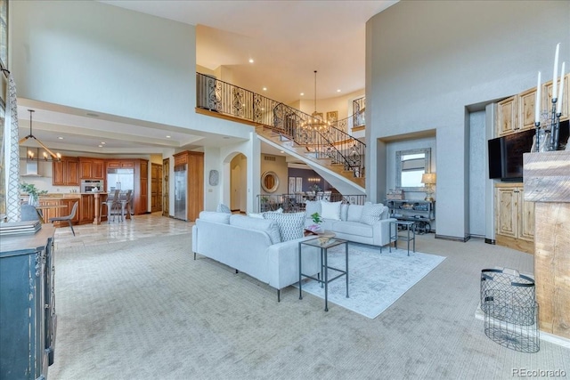 16713 W Archer Ave, Golden, CO 80401 - living room with a towering ceiling, stairs, light carpet, and recessed lighting
