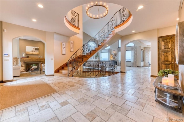 16713 W Archer Ave, Golden, CO 80401 - entryway featuring stone tile flooring, recessed lighting, stairs, baseboards, and arched walkways