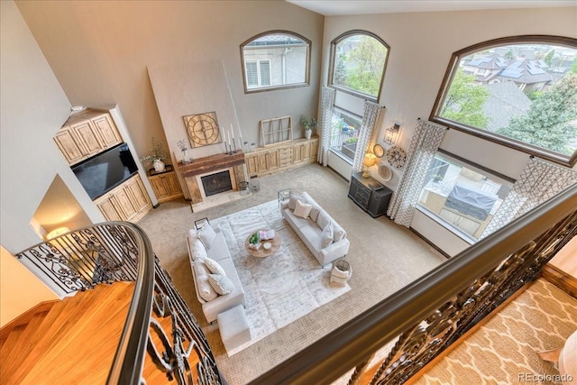 16713 W Archer Ave, Golden, CO 80401 - living room with a towering ceiling, a high end fireplace, and light carpet