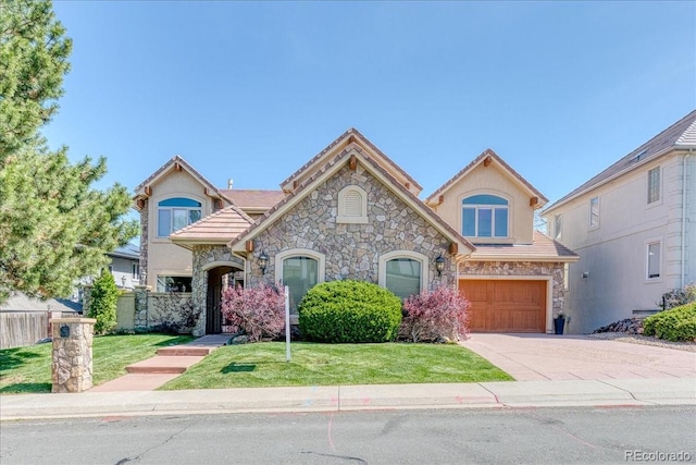 16713 W Archer Ave, Golden, CO 80401 - view of front of home featuring stone siding, an attached garage, concrete driveway, and stucco siding