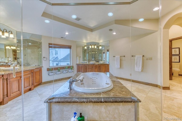 16713 W Archer Ave, Golden, CO 80401 - full bath with baseboards, a jetted tub, two vanities, recessed lighting, and tile patterned flooring
