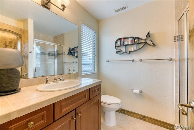 16713 W Archer Ave, Golden, CO 80401 - full bath featuring a stall shower, toilet, tile patterned floors, baseboards, and vanity