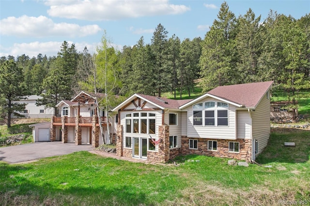 view of front of house featuring a garage and a front lawn