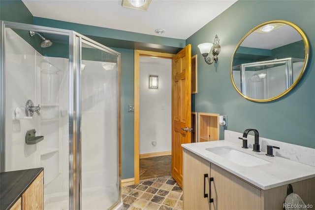 bathroom with tile flooring, a shower with shower door, and large vanity