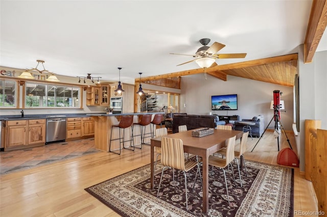 dining area with sink, vaulted ceiling with beams, light tile floors, and ceiling fan