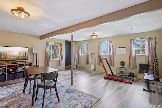 dining area featuring beamed ceiling and hardwood / wood-style floors