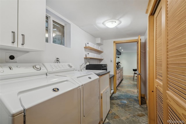 laundry room featuring cabinets, dark tile floors, electric dryer hookup, washer and clothes dryer, and sink