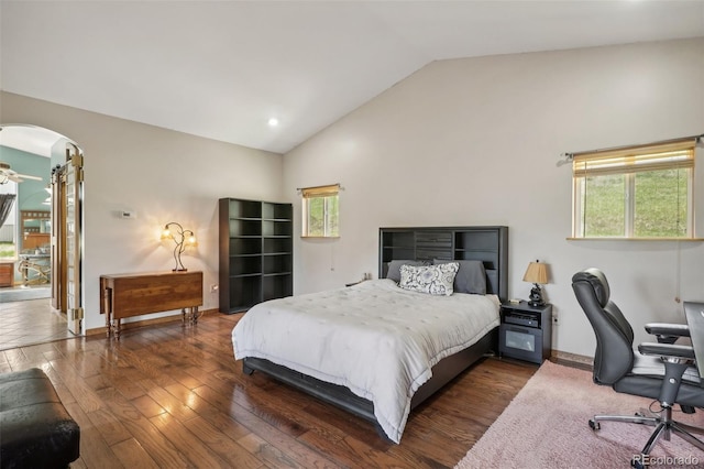 bedroom with high vaulted ceiling, hardwood / wood-style floors, and multiple windows