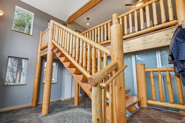 stairway featuring a towering ceiling and tile flooring