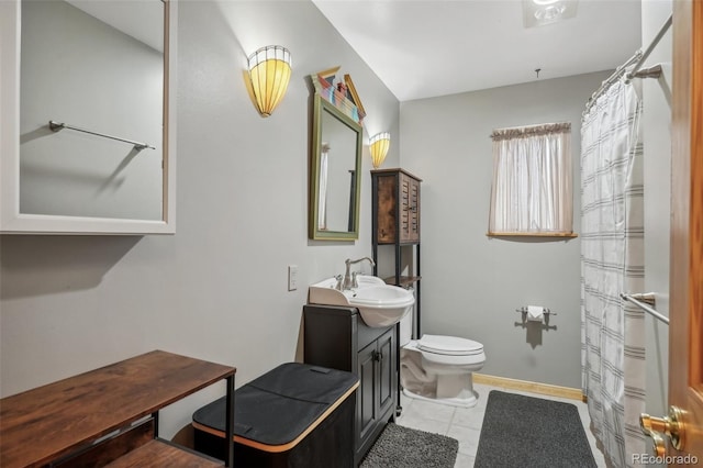 bathroom featuring tile floors, toilet, and vanity