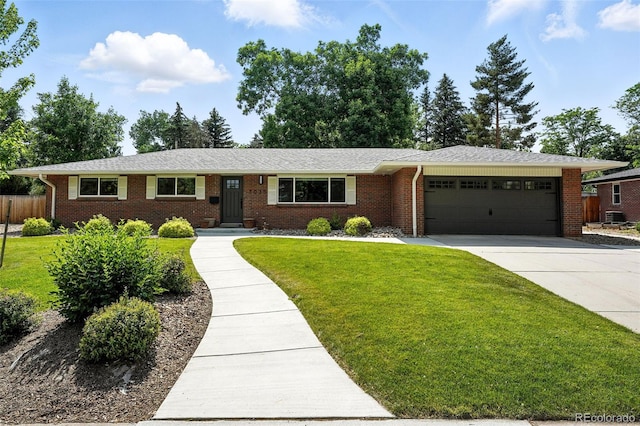7035 S Gray Ct, Littleton, CO 80128 - ranch-style house featuring a garage, brick siding, and driveway