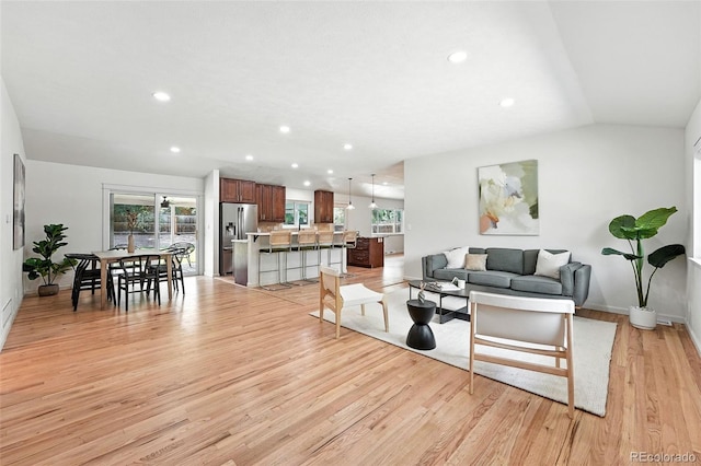 7035 S Gray Ct, Littleton, CO 80128 - living room featuring light wood-style floors, recessed lighting, and vaulted ceiling