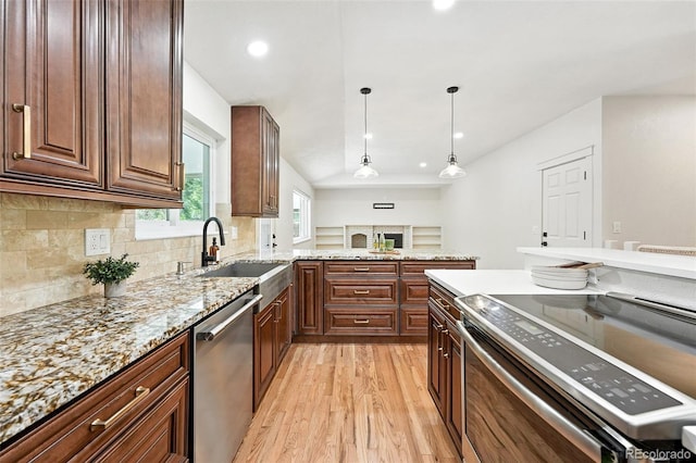 7035 S Gray Ct, Littleton, CO 80128 - kitchen with appliances with stainless steel finishes, light wood-style floors, backsplash, light stone counters, and pendant lighting