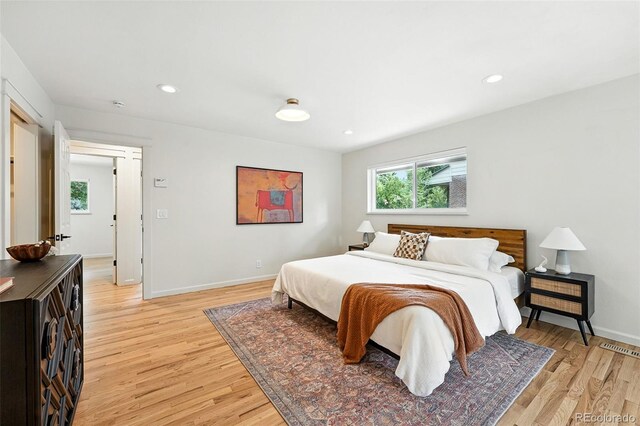7035 S Gray Ct, Littleton, CO 80128 - bedroom featuring light wood-style floors, multiple windows, and recessed lighting