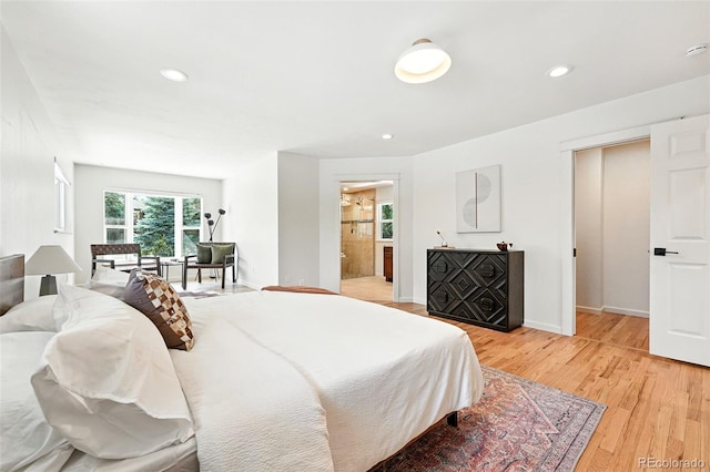 7035 S Gray Ct, Littleton, CO 80128 - bedroom with light wood-type flooring, recessed lighting, and ensuite bath