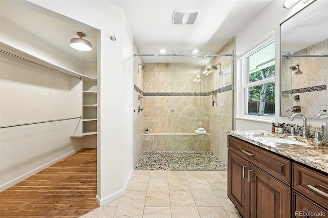 7035 S Gray Ct, Littleton, CO 80128 - full bathroom featuring a tile shower and vanity