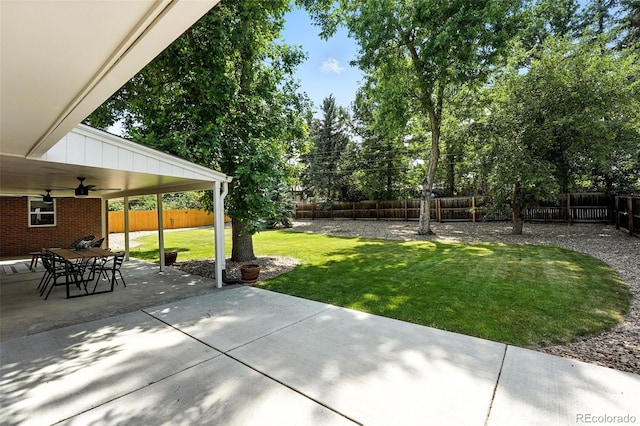 7035 S Gray Ct, Littleton, CO 80128 - fenced backyard with ceiling fan and a patio