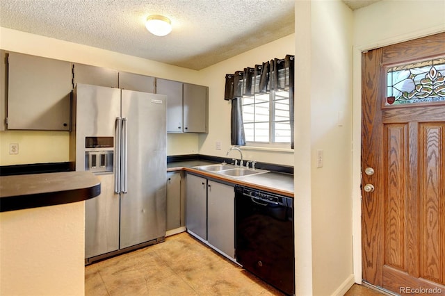 kitchen featuring dishwasher, gray cabinets, sink, and high quality fridge