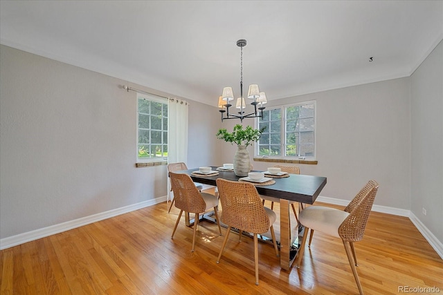 2065 Leyden St, Denver, CO 80207 - dining space with a chandelier, light wood-type flooring, baseboards, and crown molding