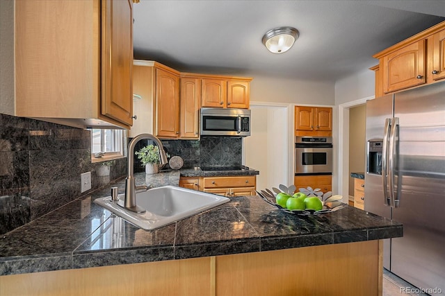2065 Leyden St, Denver, CO 80207 - kitchen featuring stainless steel appliances, tile countertops, a sink, a peninsula, and tasteful backsplash