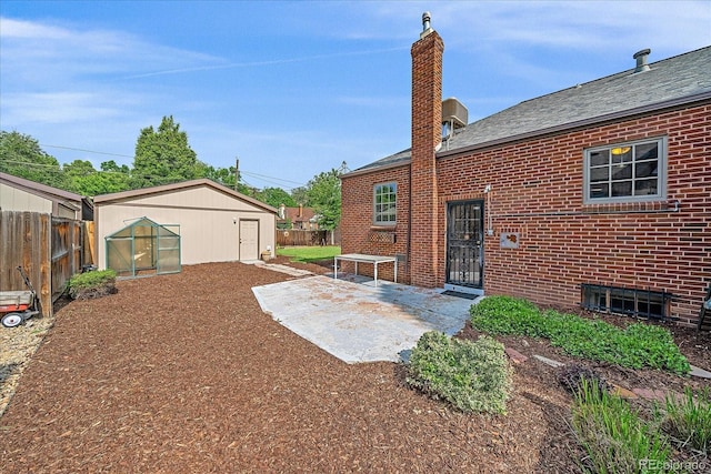 2065 Leyden St, Denver, CO 80207 - fenced backyard with a patio area and an outbuilding
