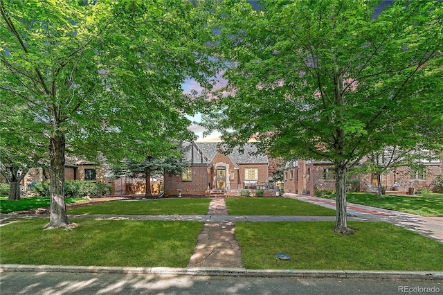 2065 Leyden St, Denver, CO 80207 - tudor home featuring a front yard and brick siding