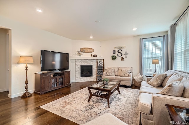16043 Fillmore St, Thornton, CO 80602 - living room featuring dark wood-type flooring, a stone fireplace, and recessed lighting
