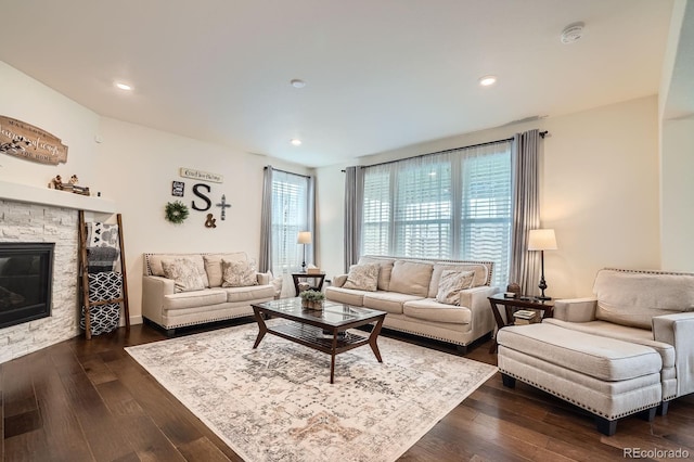 16043 Fillmore St, Thornton, CO 80602 - living room with healthy amount of natural light, a fireplace, dark wood-type flooring, and recessed lighting