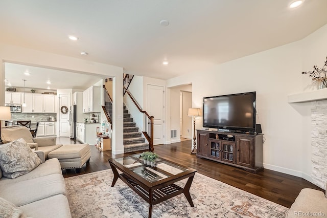 16043 Fillmore St, Thornton, CO 80602 - living room featuring stairway, dark wood finished floors, and recessed lighting