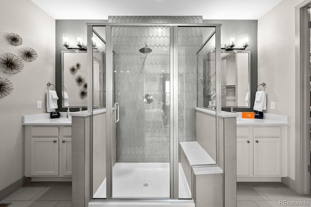 bathroom featuring tile patterned flooring, vanity, and a shower with door