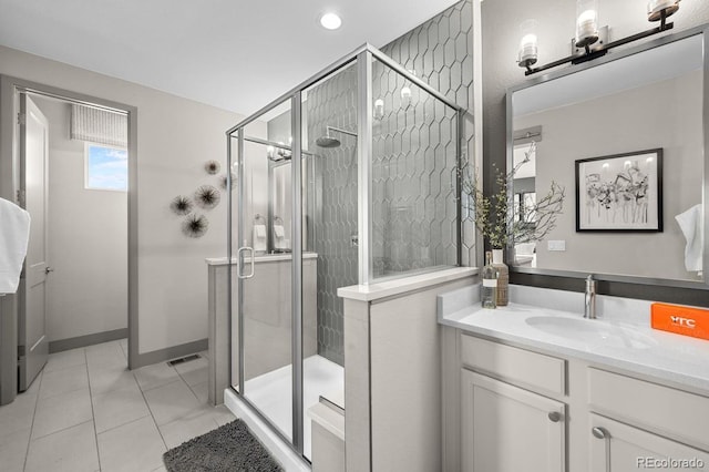 bathroom featuring vanity, tile patterned floors, and a shower with door