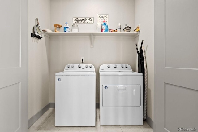 washroom with separate washer and dryer and light tile patterned flooring