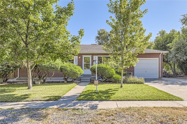 view of property hidden behind natural elements featuring a garage and a front yard